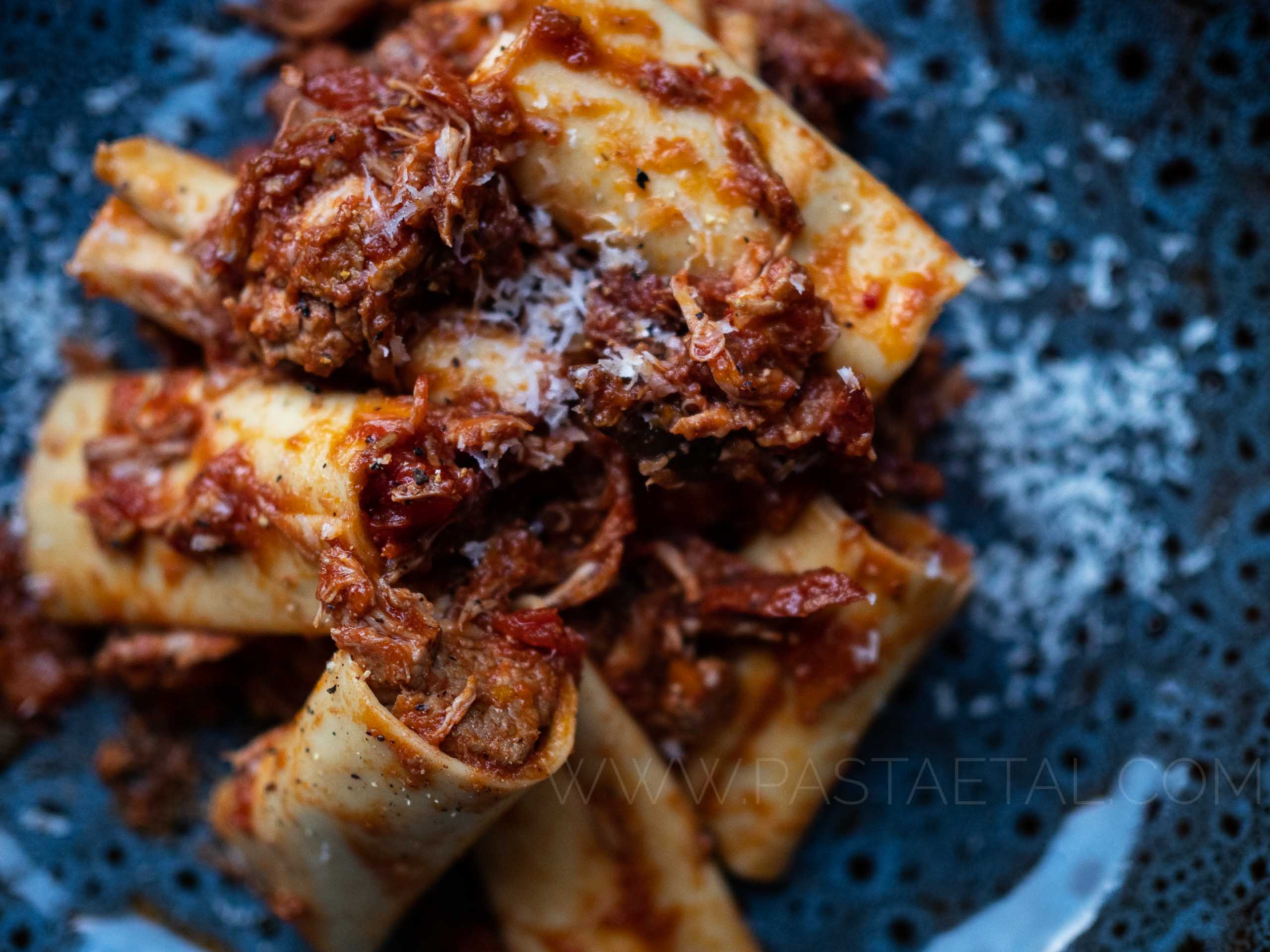 https://pastaetal.com/wp-content/uploads/2020/05/blog-close-up-of-paccheri-pasta-stuffed-with-pork-shoulder-ragu.jpg