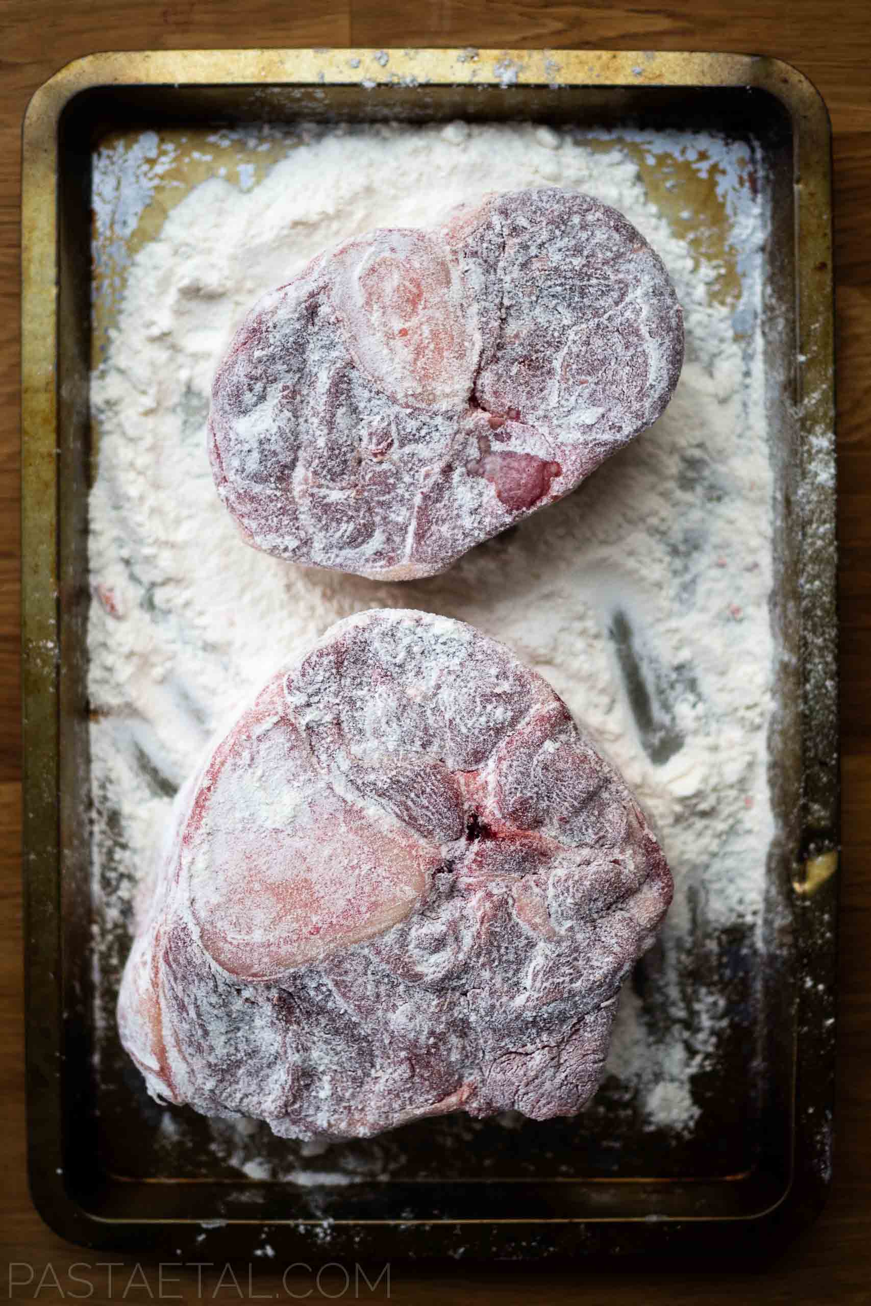 https://pastaetal.com/wp-content/uploads/2020/07/osso-bucco-dredged-with-flour-in-a-baking-tray.jpg