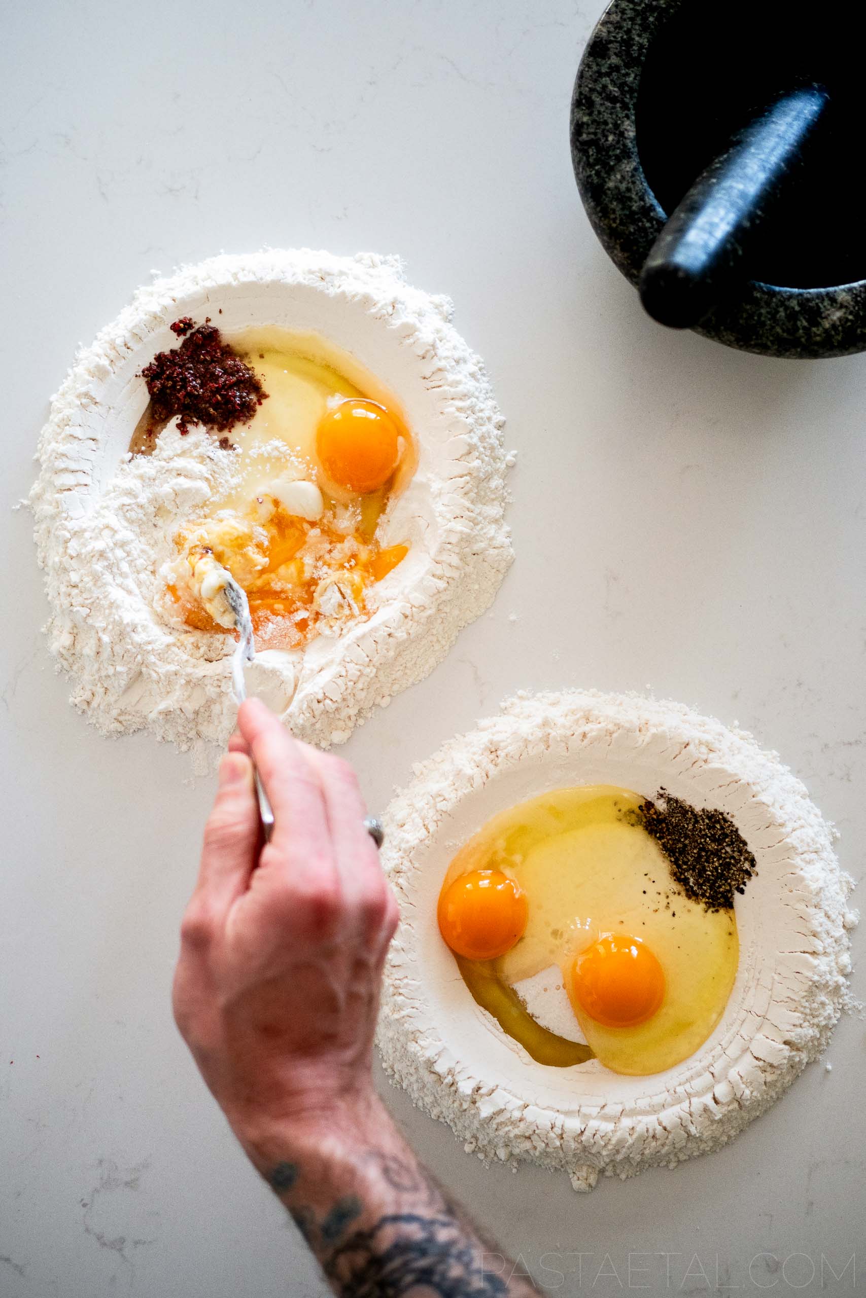 https://pastaetal.com/wp-content/uploads/2023/09/Pink-and-Black-Peppercorn-Pasta-Doughs-Being-Mixed-Together-on-a-Benchtop.jpg